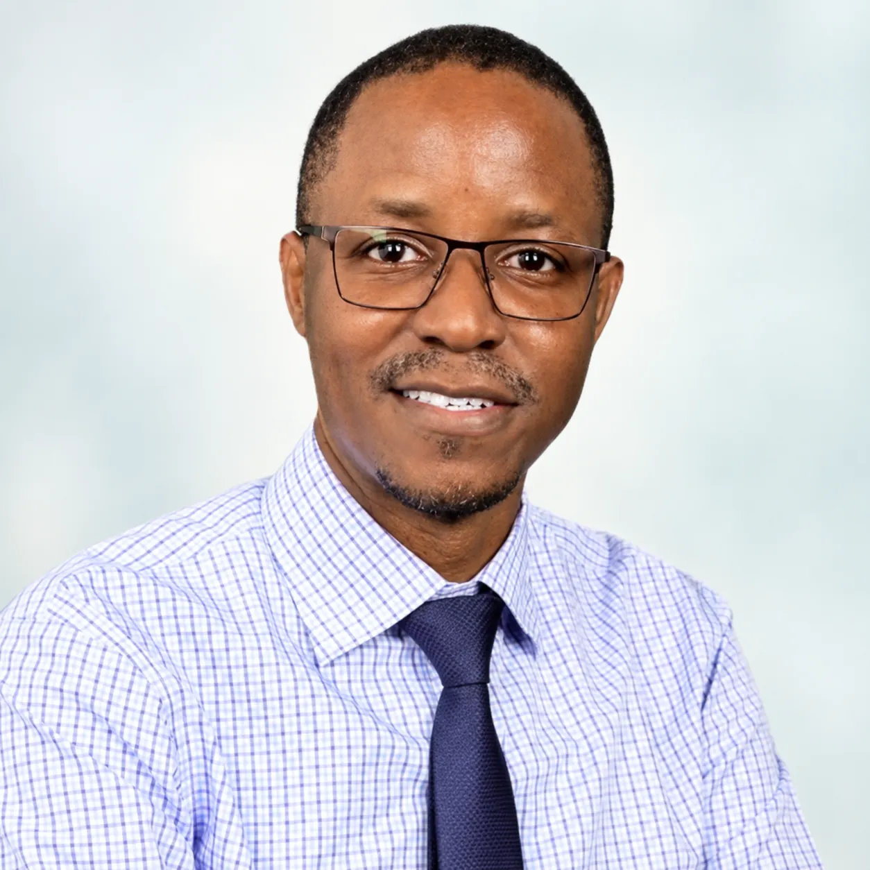 Dr. George William Galiwango smiling in a professional portrait